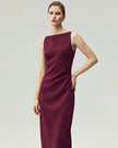 Burgundy pleated-waist dress on model, front view showing the straight neckline and fitted pleated waist