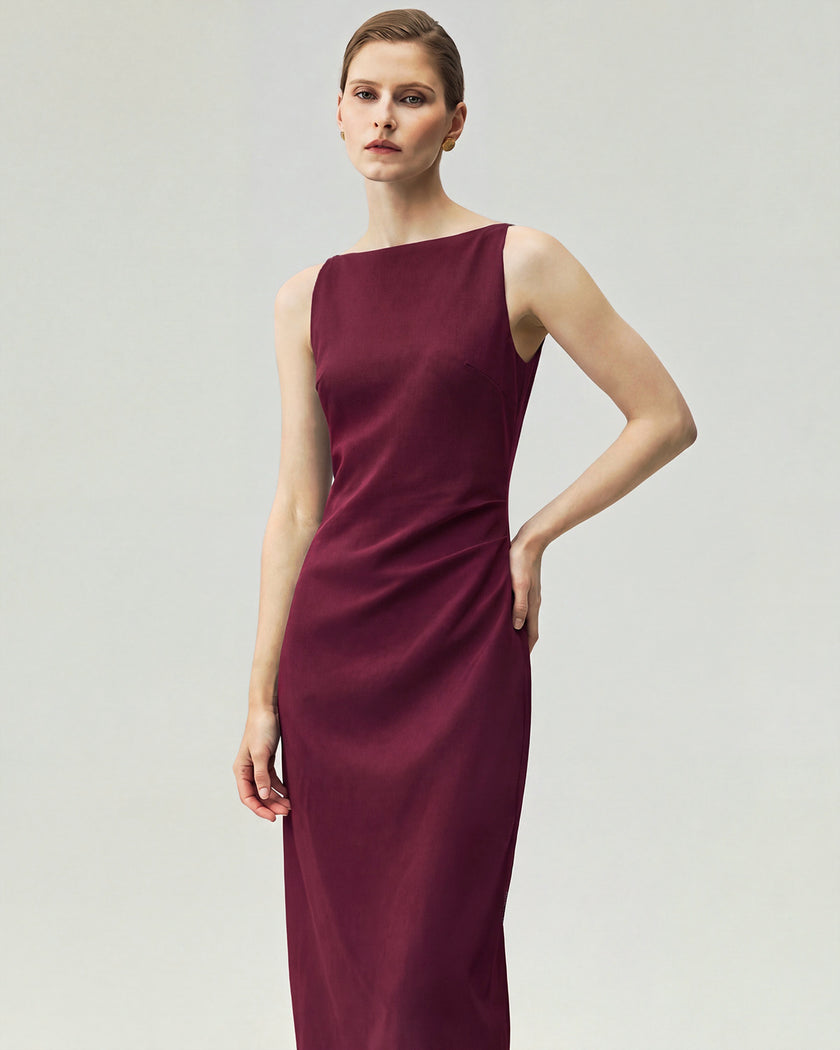 Burgundy pleated-waist dress on model, front view showing the straight neckline and fitted pleated waist