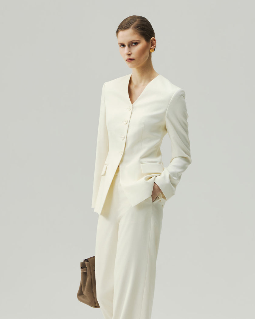 Vanilla sculpted jacket on model, three-quarter view highlighting the four-button front