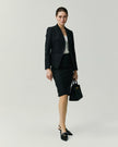 Black York Skirt on model, full-length front view showing the slim knee-length silhouette