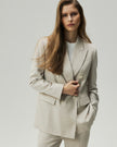 atmeal Check Kai Blazer on model, front view showing the double-breasted closure and peak lapels