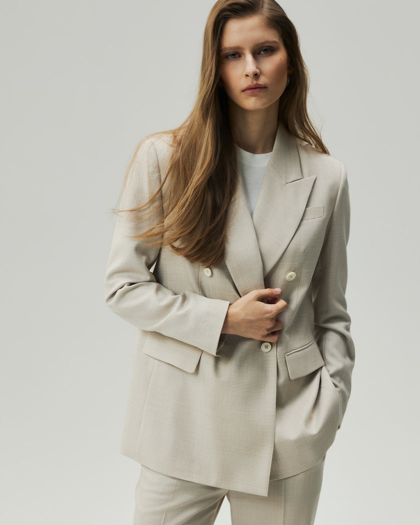 atmeal Check Kai Blazer on model, front view showing the double-breasted closure and peak lapels