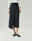 Charcoal Grey wrap skirt on model, lower-body view showing the asymmetric diagonal hem