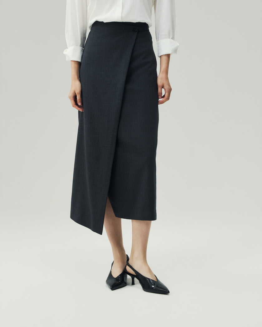 Charcoal Grey wrap skirt on model, lower-body view showing the asymmetric diagonal hem