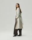 Oatmeal Beige trench coat on model, side styling view showing the adjustable waist belt