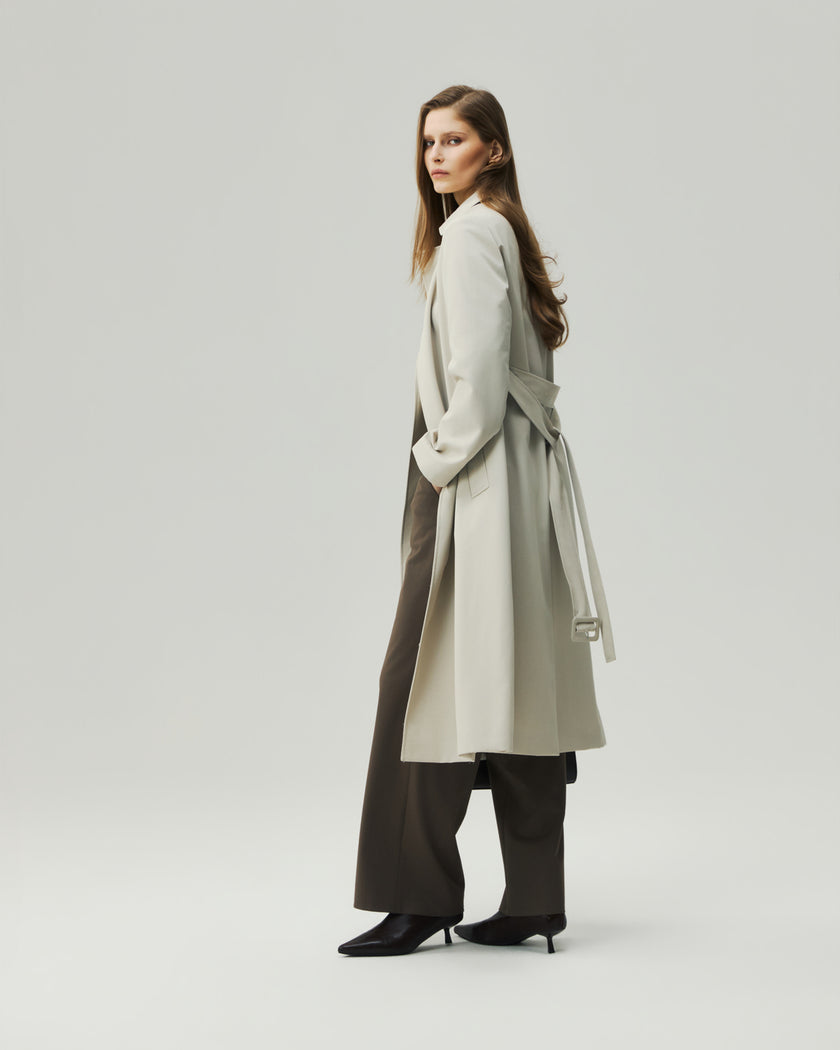 Oatmeal Beige trench coat on model, side styling view showing the adjustable waist belt