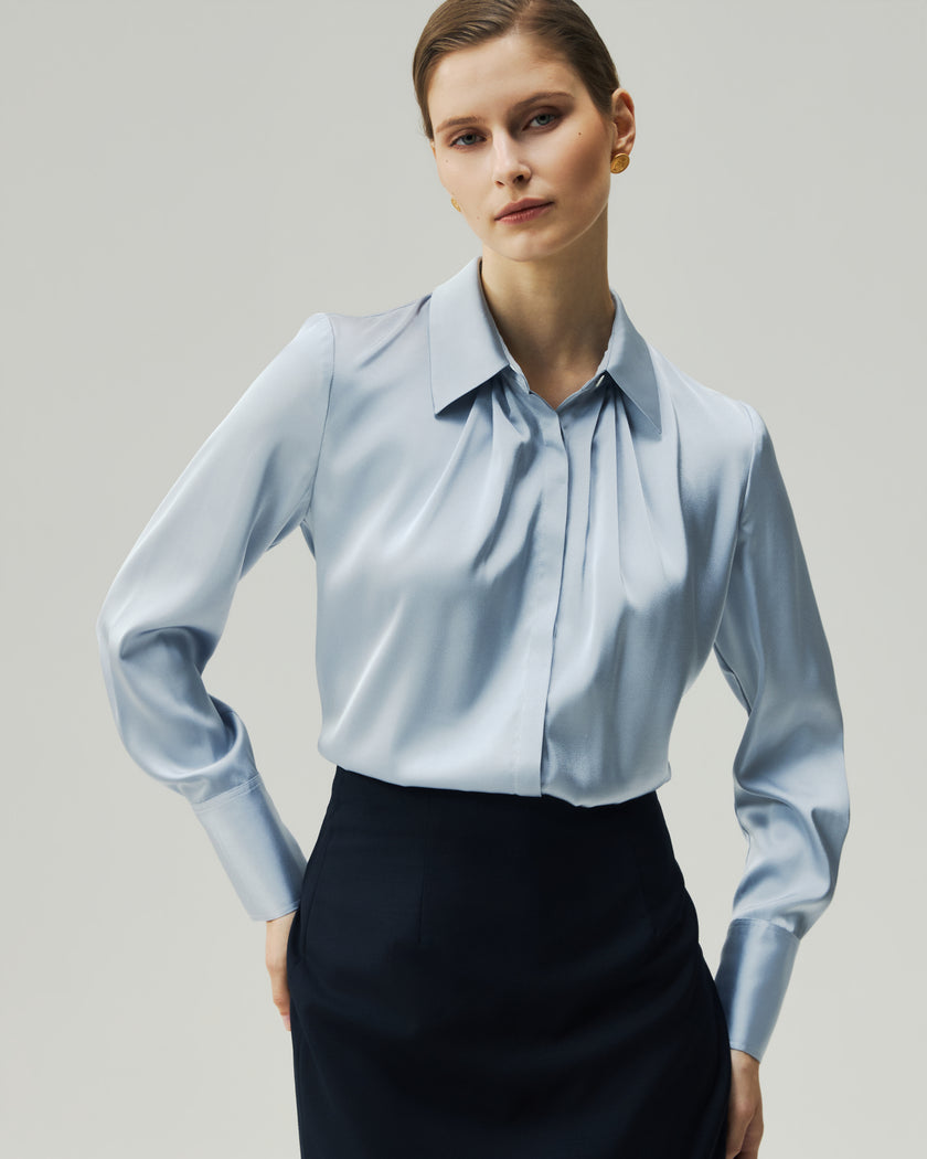 Glacier Blue blouse, close-up front view showing the pleated square neckline and concealed placket