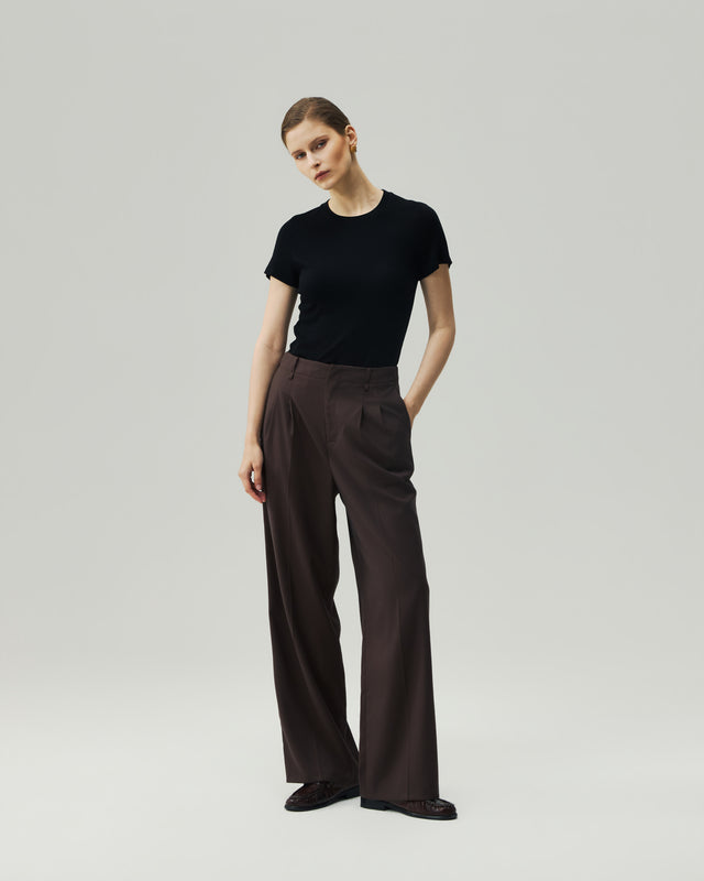 Black fitted T-shirt on model, full-length front view