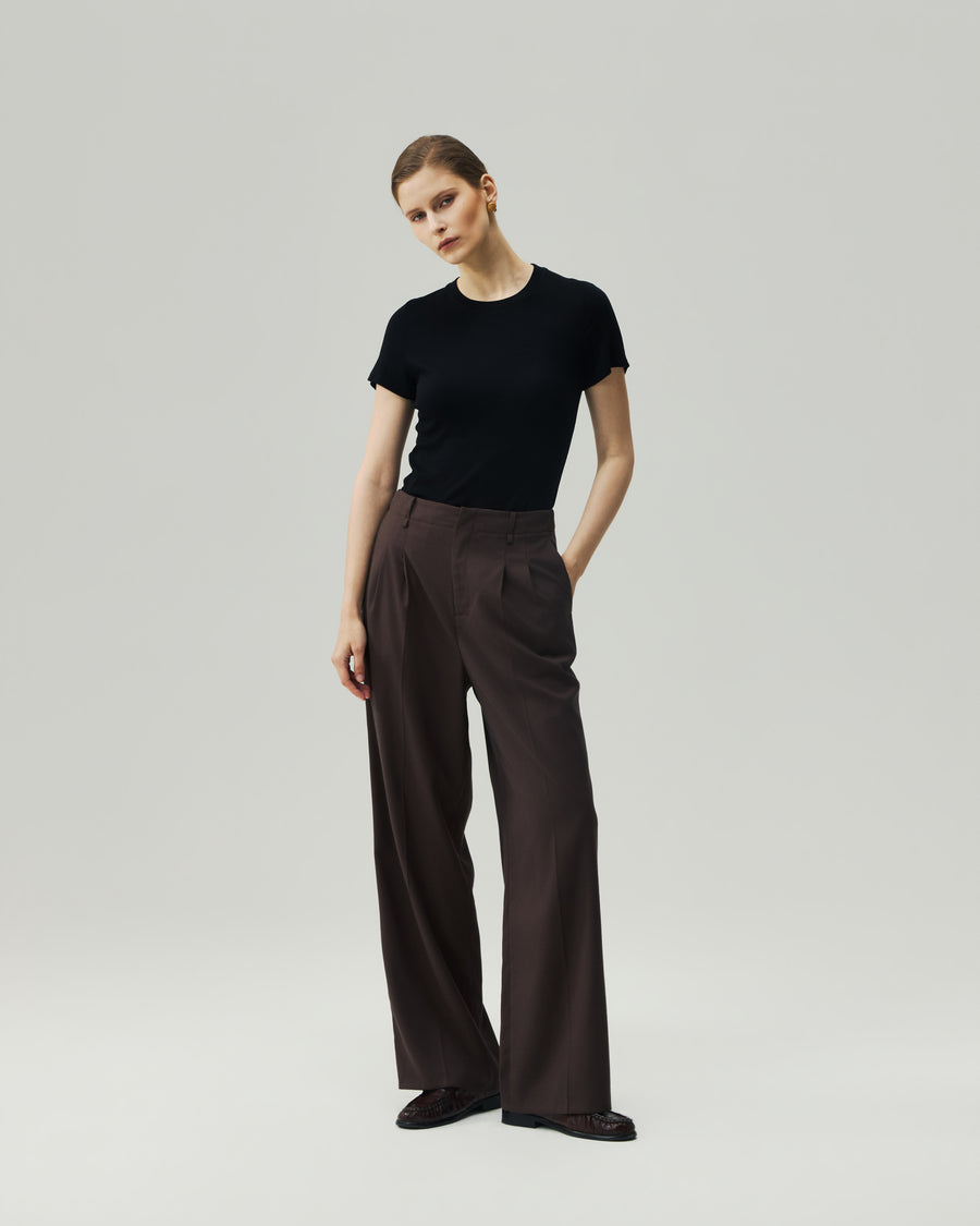 Black fitted T-shirt on model, full-length front view