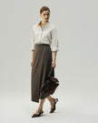 Oatmeal fitted shirt on model, three-quarter view showing the curved hem and relaxed sleeve shape