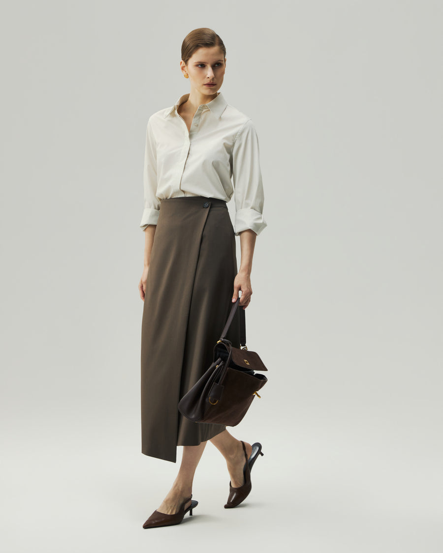 Oatmeal fitted shirt on model, three-quarter view showing the curved hem and relaxed sleeve shape