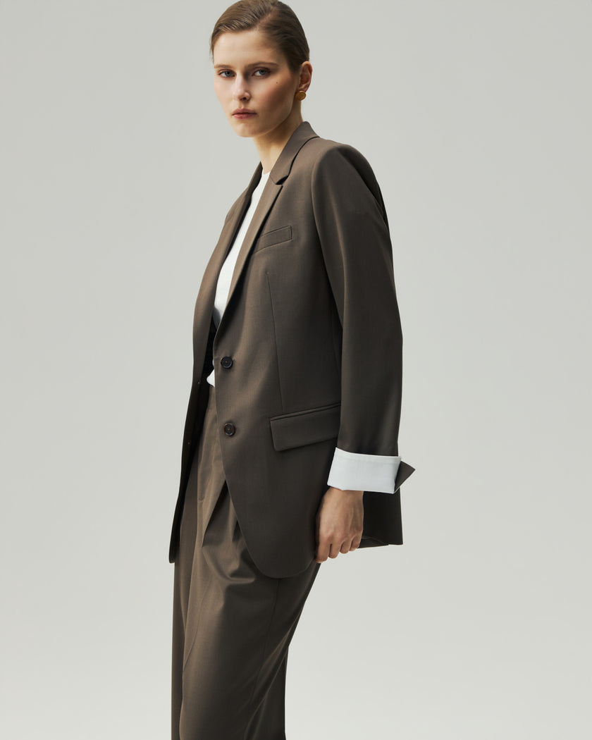 Single-Breasted Blazer in Warm Tea Brown on model, side view highlighting the subtle waist shaping