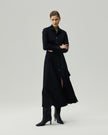 Black shirt dress on model, full-length front view showing the button-front closure and belted waist