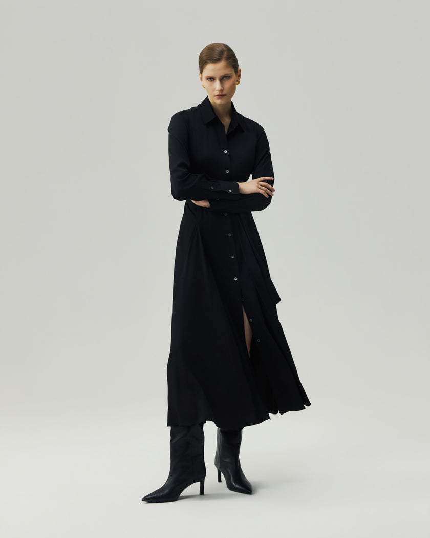 Black shirt dress on model, full-length front view showing the button-front closure and belted waist