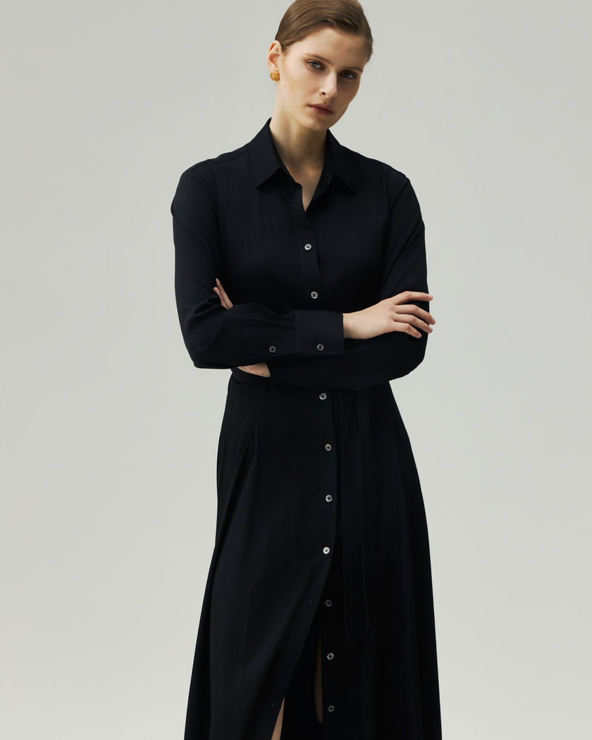 Black shirt dress on model, front view showing the softly flared skirt