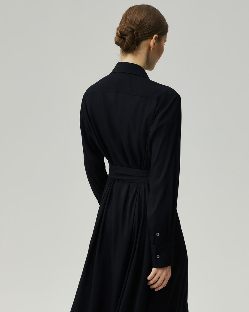 Shirt Dress in Black on model, back view showing the long sleeves and clean silhouette
