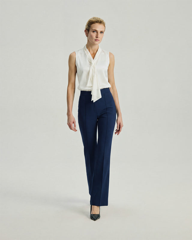 Gandi Trousers in Navy on model, full-length front styling view