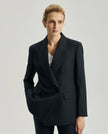 Model wearing the Kai charcoal grey blazer with structured peak lapels and a relaxed fit