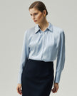 Glacier Blue blouse on model, front view showing the square neckline and long sleeves