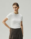 White fitted T-shirt on model, front view showing the crew neckline and short sleeves