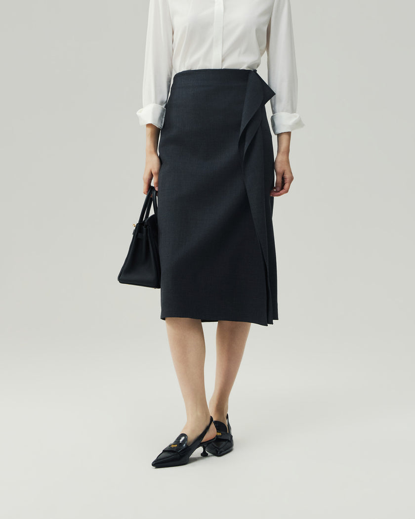 Charcoal Grey asymmetric skirt on model, front view showing the draped overlay and slit