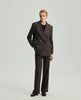 Model wearing the Kai double-breasted blazer in ebony with matching trousers