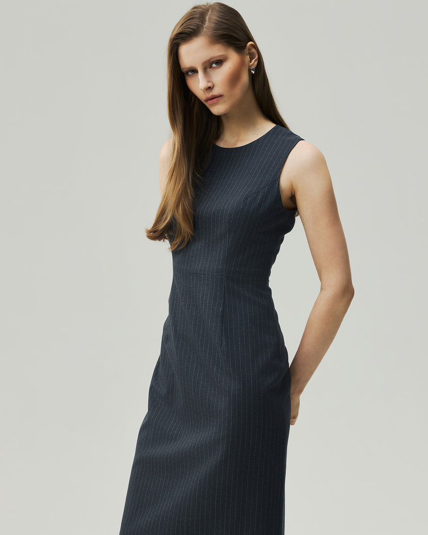 Grey pinstripe midi dress, three-quarter front view showing the fitted bodice and waist
