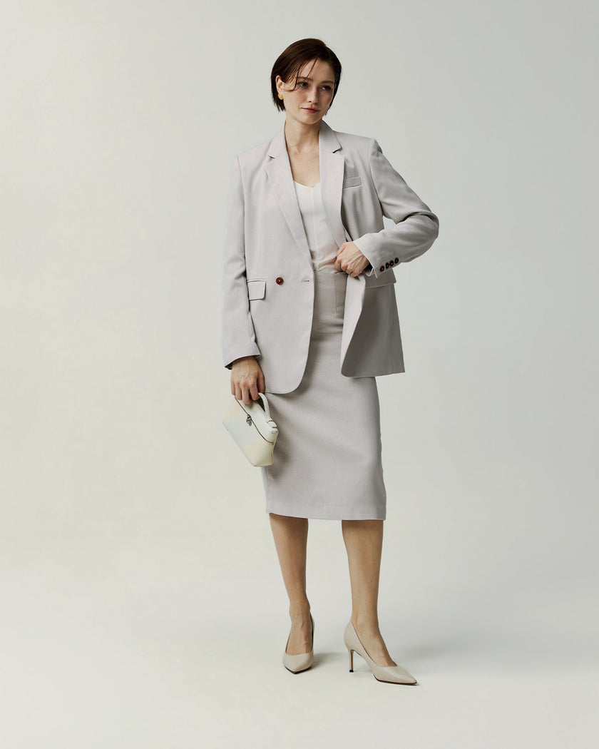 Almond pencil skirt on model, showing the fitted waist and straight silhouette