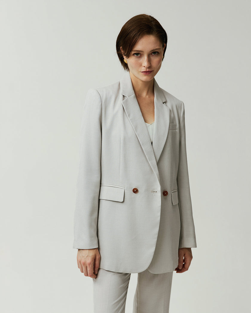 Almond Kew Blazer on model, front view showing the double-breasted closure and notched lapels