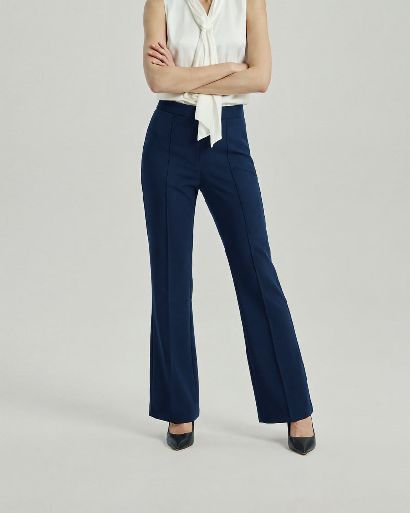 Navy Gandi Trousers on model, lower-body front view showing the high-rise waist and straight-leg silhouette