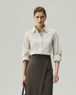 Oatmeal tailored shirt on model, front view showing the fitted waist and button-front closure