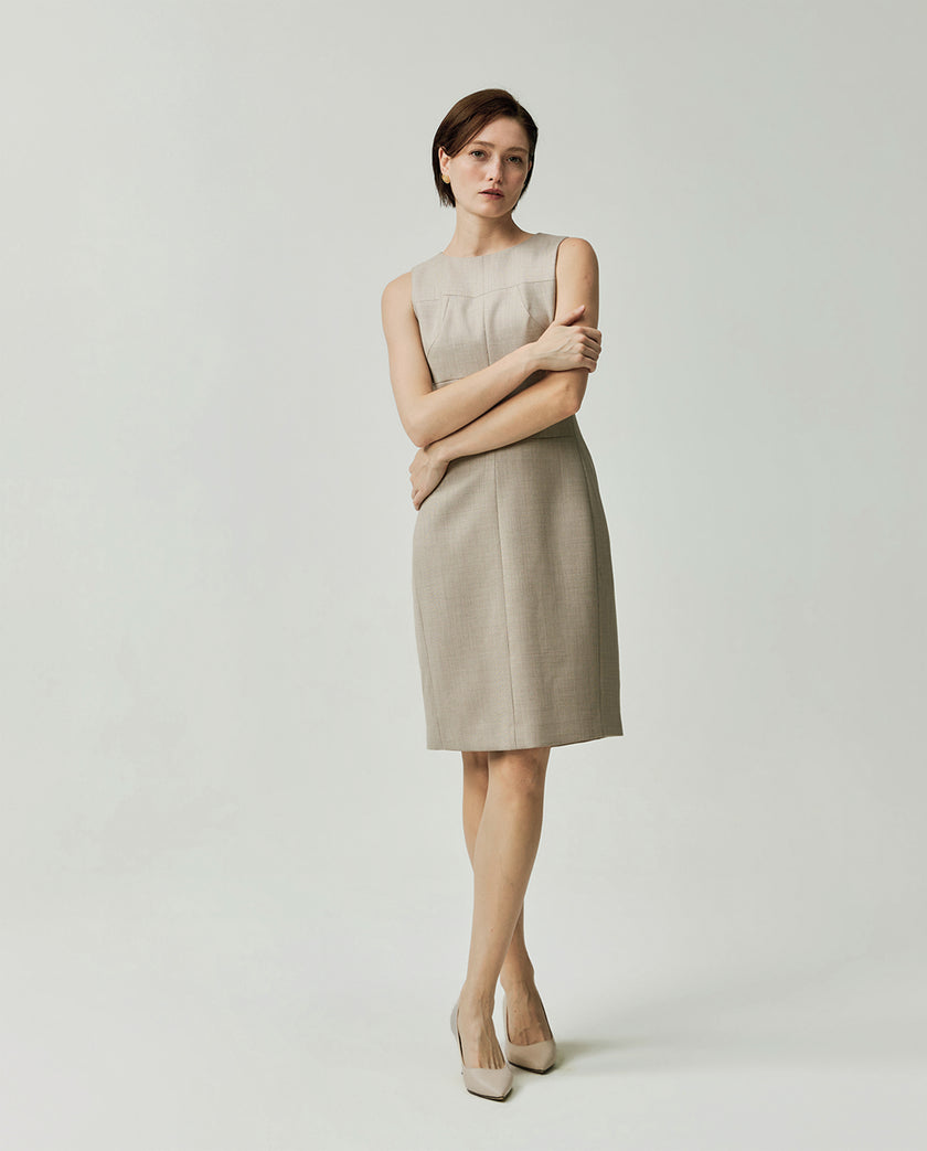 Model wearing the Curie textured apricot dress showing its fitted silhouette and straight skirt
