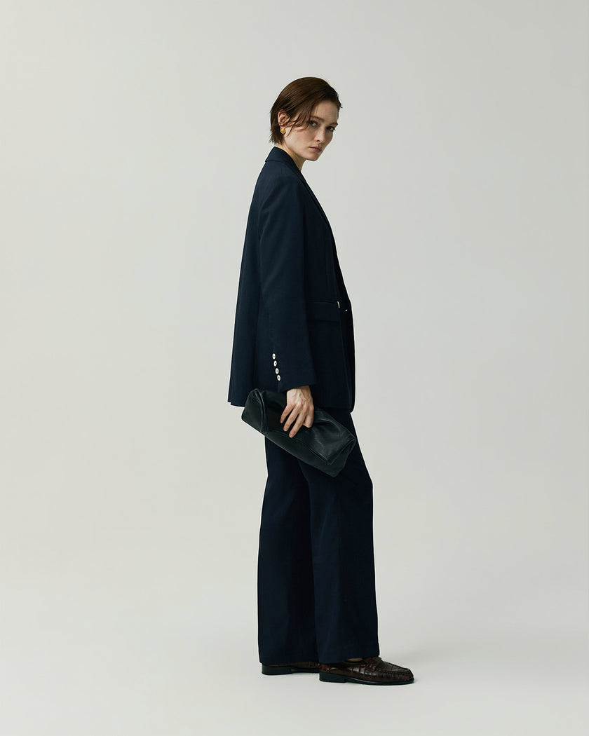 Navy Kew Blazer on model, side view showing the slim tailored silhouette, styled with matching trousers