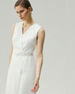 Almond White wrap dress, close-up showing the deep V neckline and self-fabric waist belt