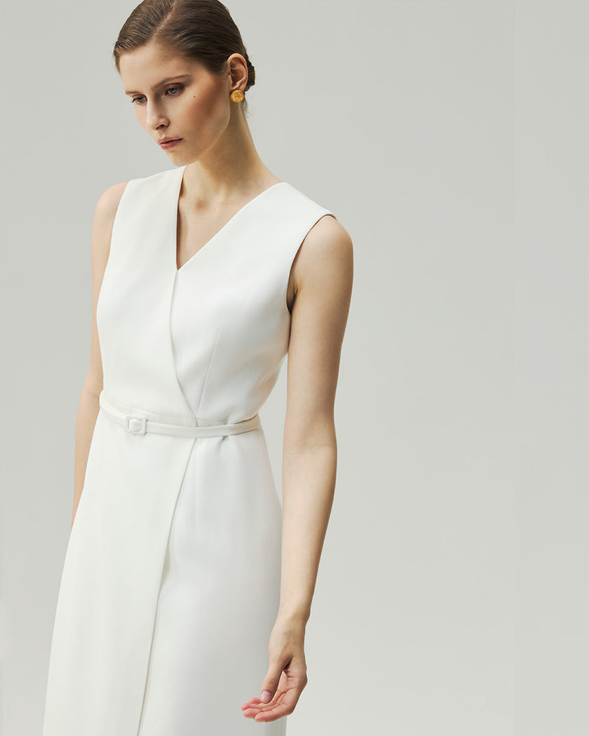 Almond White wrap dress, close-up showing the deep V neckline and self-fabric waist belt