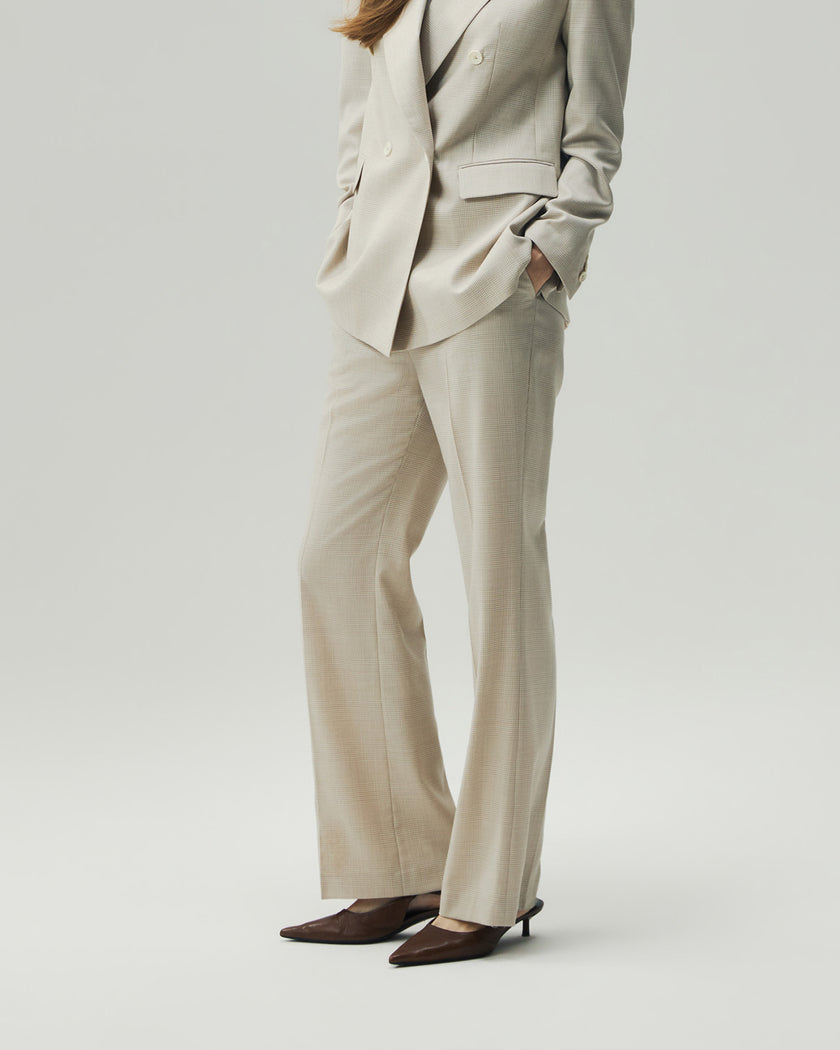 Oatmeal Check straight-leg trousers on model, showing the high-rise waist and clean leg