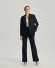 Model wearing the Kai double-breasted blazer in charcoal grey with matching trousers