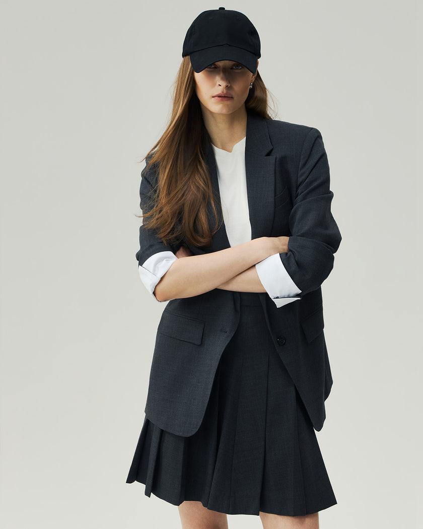 Charcoal Grey single-breasted blazer styled with a skirt, full-length layered look on model