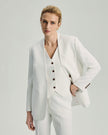 White Wells Blazer on model, front view showing the collarless outer jacket and V-neck inner vest