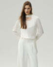 Cloud White reversible blouse on model, front view showing the clean neckline and long sleeves