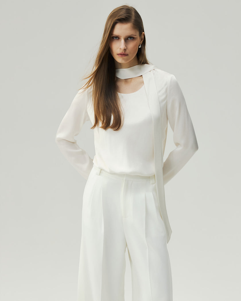 Cloud White reversible blouse on model, front view showing the clean neckline and long sleeves