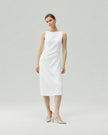 Dress in Almond White on model, highlighting the hand-pinched pleats at the waist