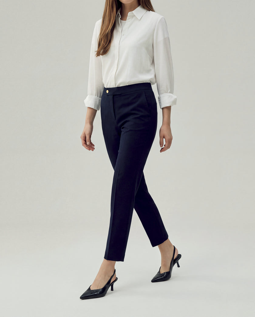 Elena Trousers in Dark Navy Check, three-quarter view highlighting the fitted hips and clean cropped leg