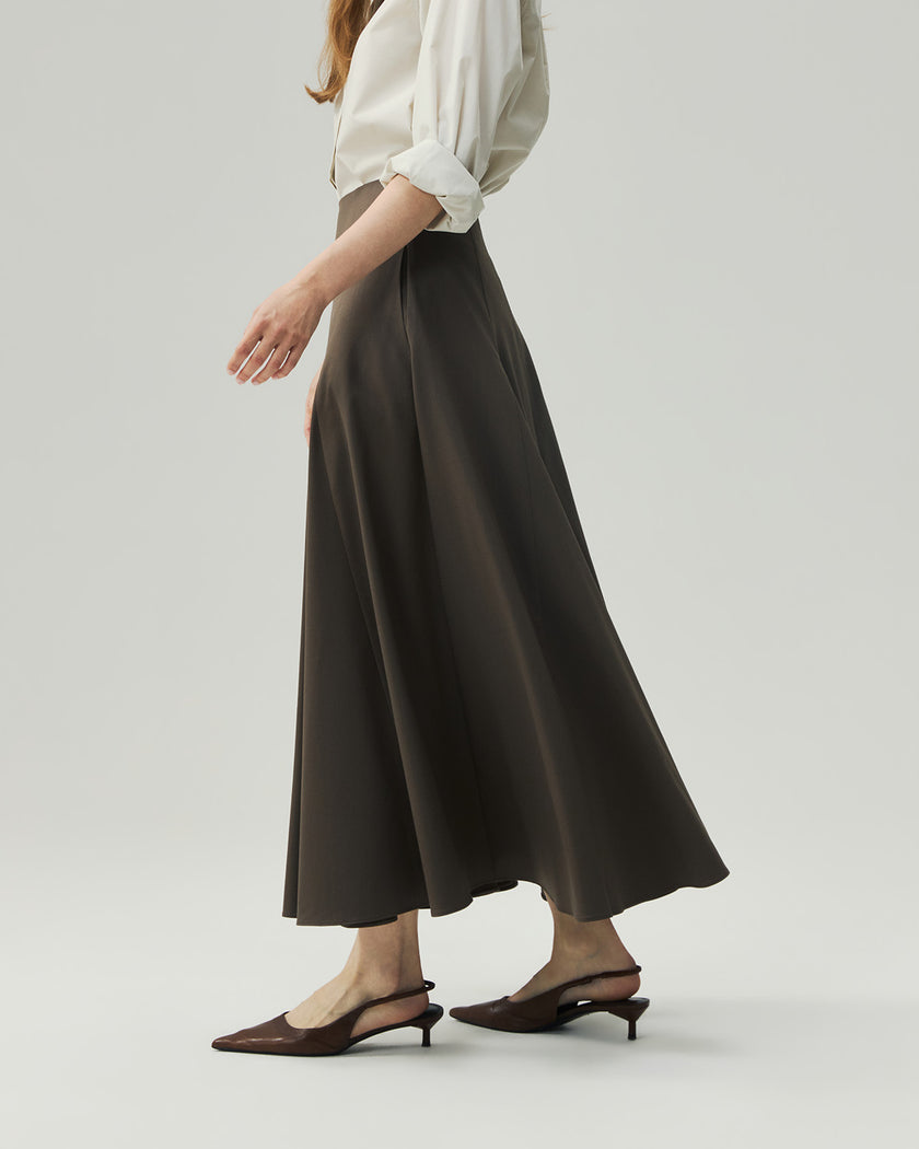 Warm Tea Brown sculpted midi skirt on model, side view showing the high-rise waist and full A-line shape