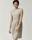 Close-up of the Curie textured apricot dress featuring a round neckline and precision panel seaming