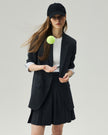 Mini Skirt in Charcoal Grey on model, side styling view showing the flared silhouette