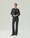 Model wearing Gandi charcoal grey tailored trousers with a matching Gabri jacket