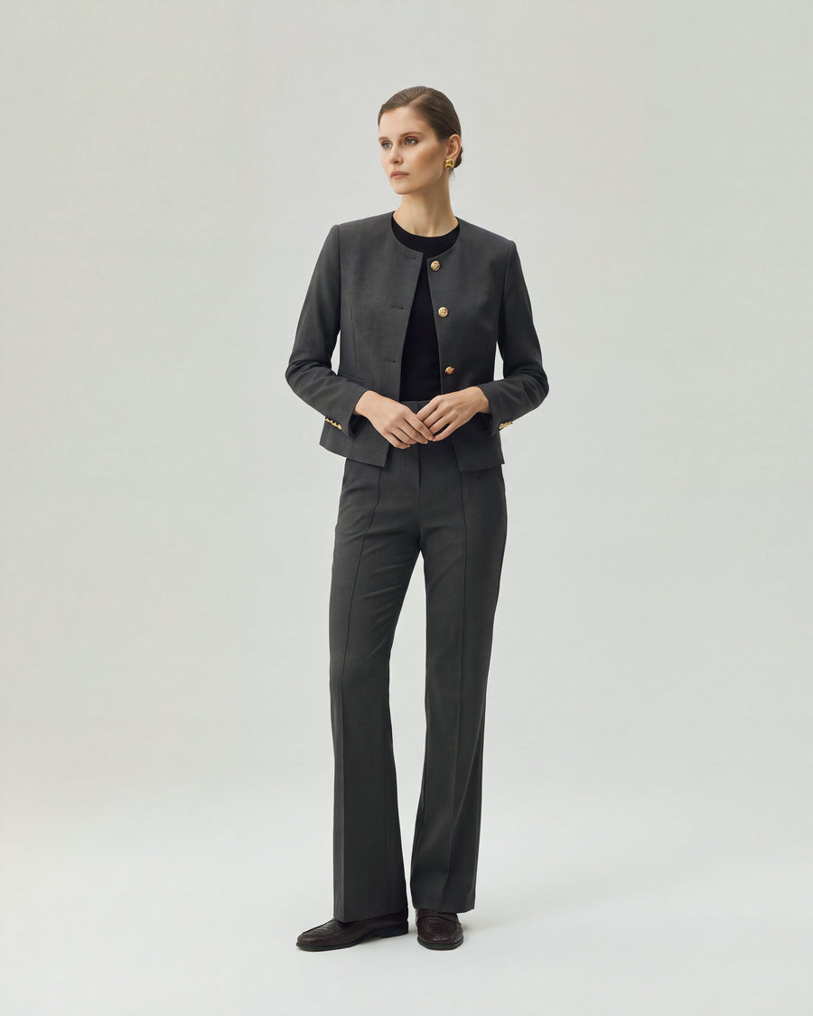 Model wearing Gandi charcoal grey tailored trousers with a matching Gabri jacket