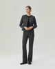 Model wearing Gandi charcoal grey tailored trousers with a matching Gabri jacket