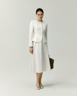 Model wearing the Naya A-line skirt in white with a matching white jacket
